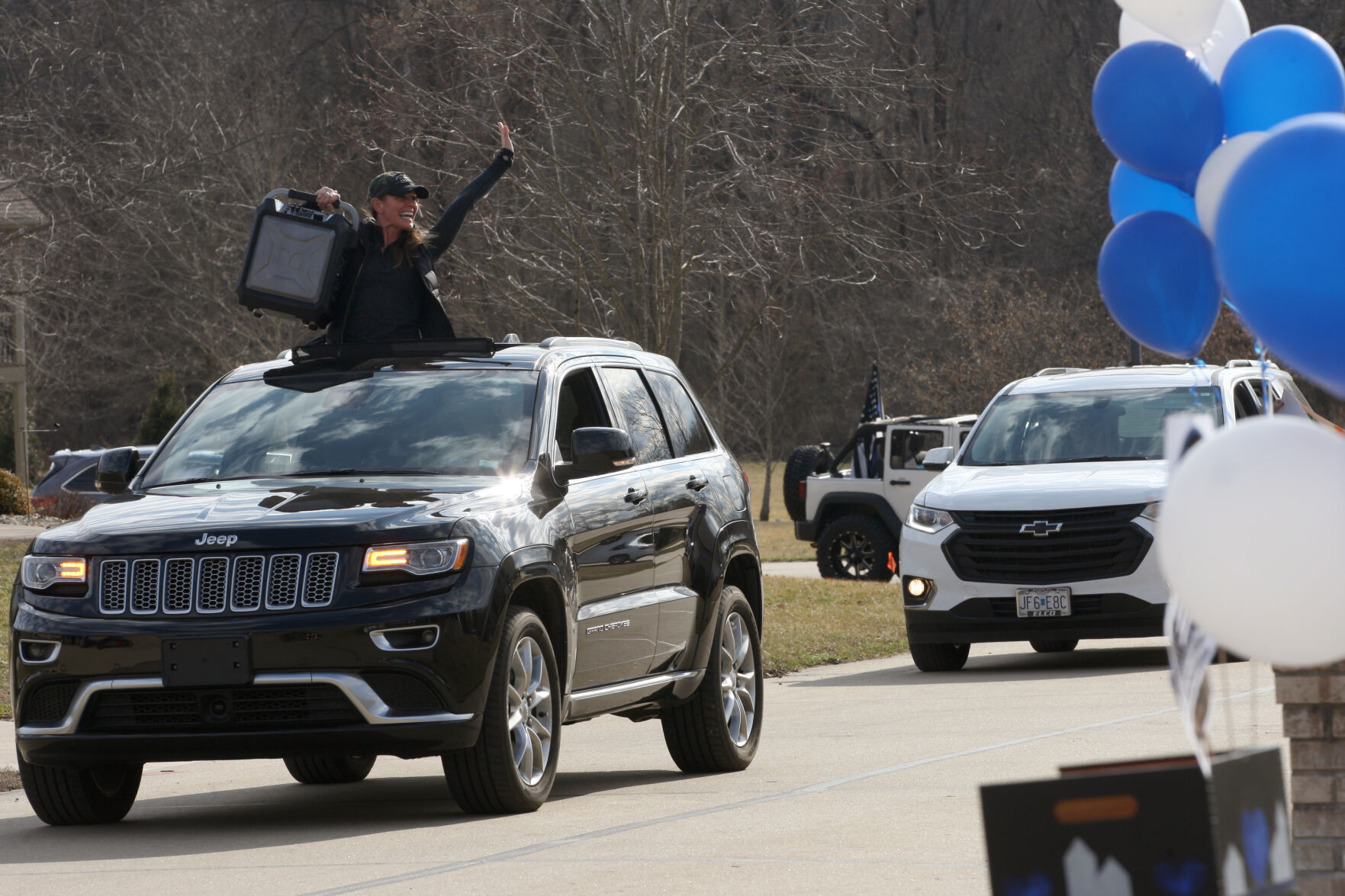 Waving to welcome John Wilson home